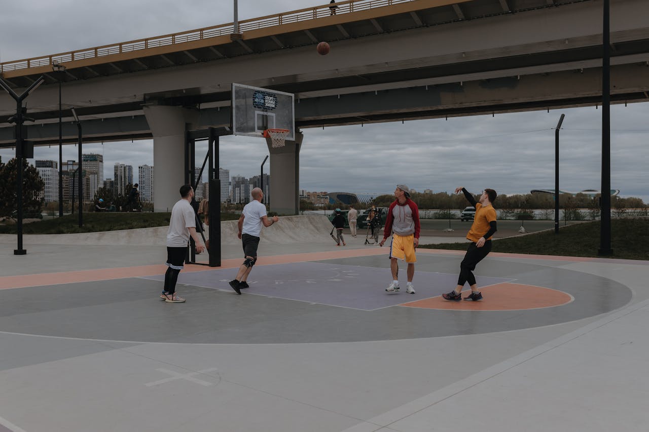 A group of people playing basketball on a court